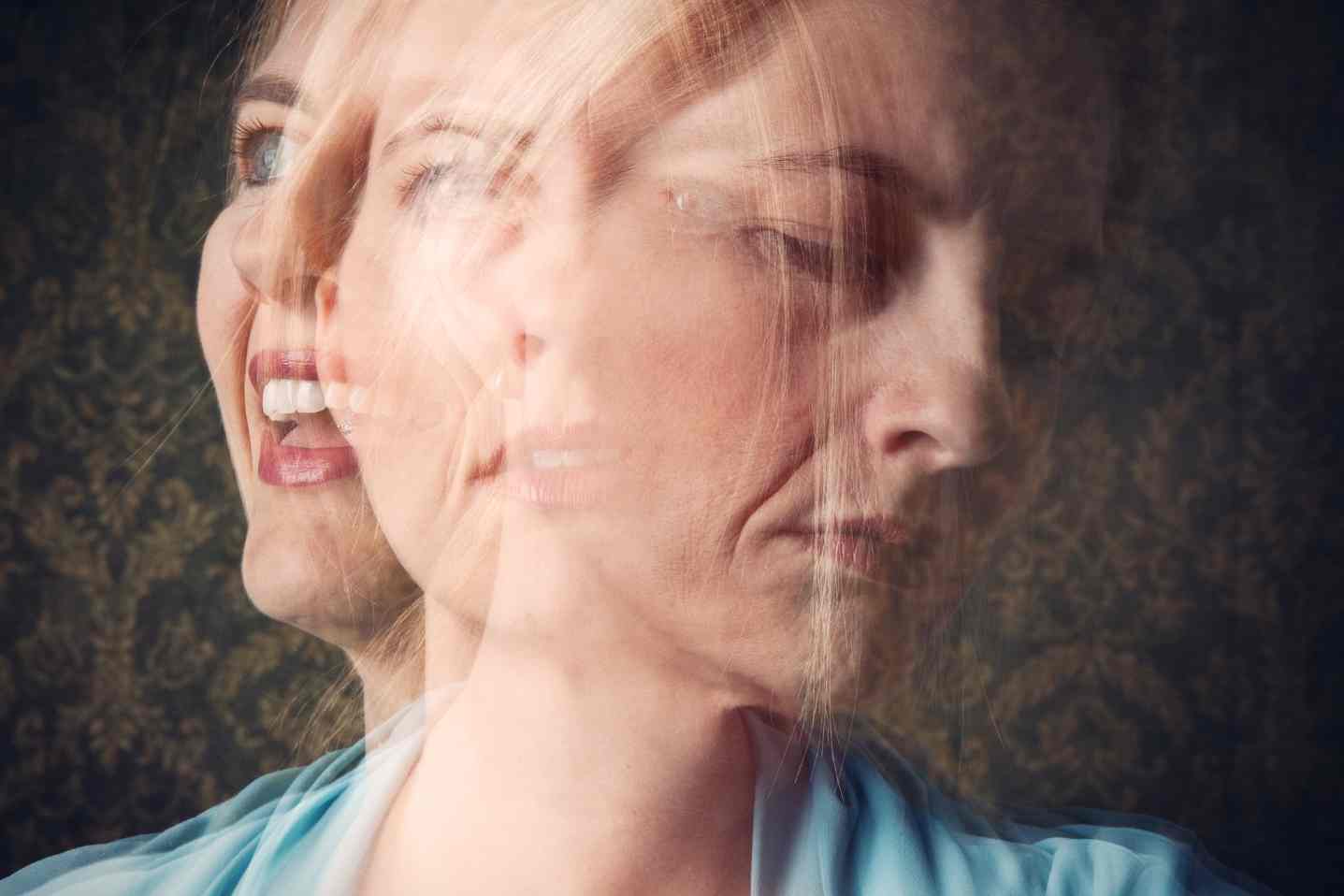 Double exposure of woman showing contrasting emotions, happy and sad.