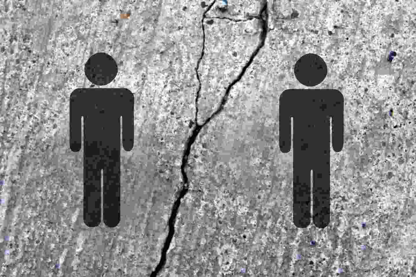 Two human icons separated by a crack symbolizing division or conflict